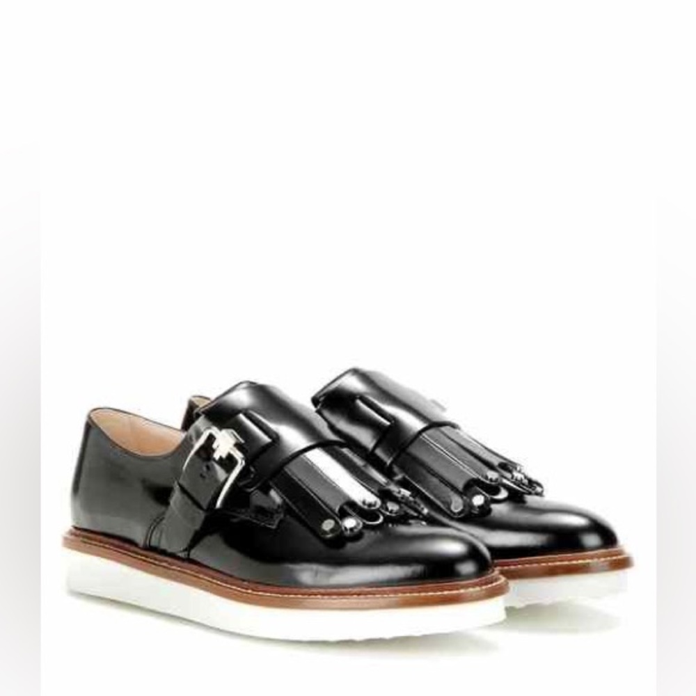 Tod’s black patent fringe loafers with metal clasps